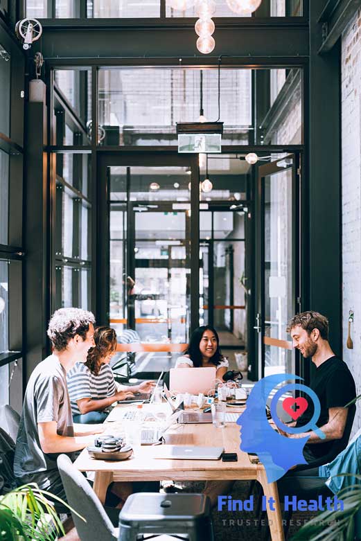 Finding an ergonomic seat cushion for office chair young workers around a table with laptops